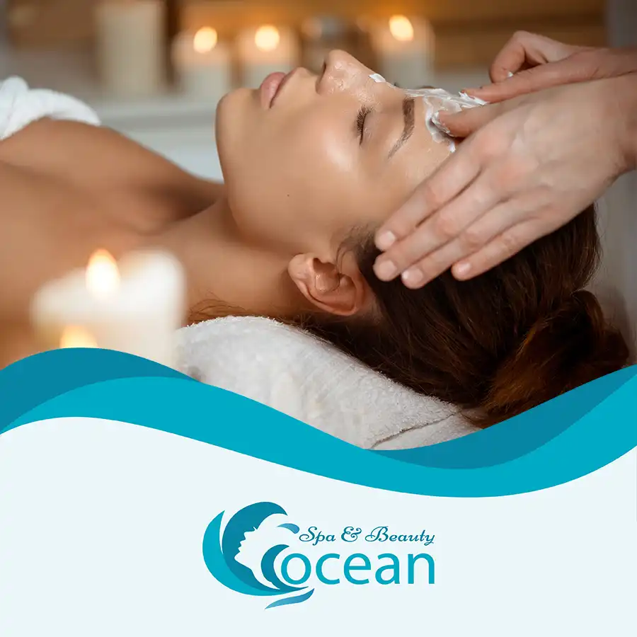 Spa therapist gently massaging a client's face during a relaxing facial treatment at Ocean Spa Hoi An